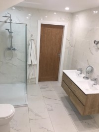 Bathroom installation in Cavan with shower and marble effect tiling by North West Tiles & Timber, Ireland