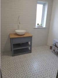 Counter top basin with patterned floor tiles and brick effect  wall tiles in a new bathroom  installed  by North West Tiles & Timber, Leitrim, Ireland