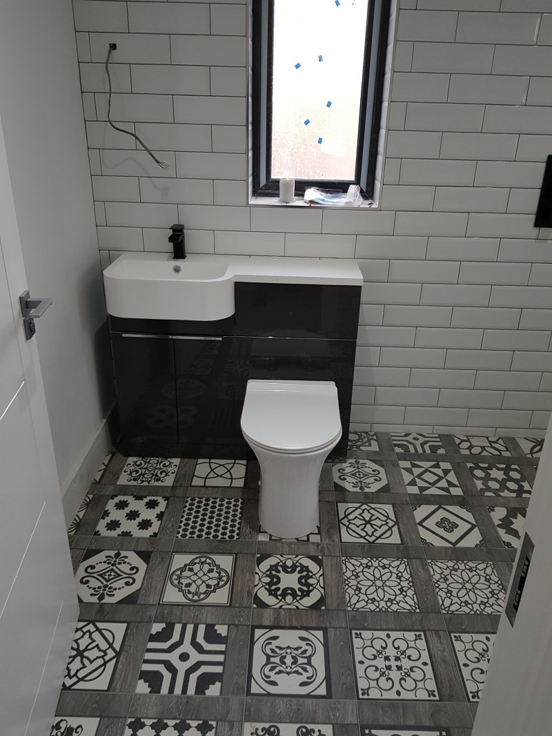 Patterned bathroom floor tiles,  toilet and  basin with subway wall tiles  in a Kilmore, County  Longford home installed by North West Tiles & Timber, Ireland
